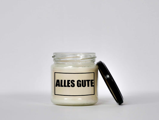 Transparente Glas-Kerze mit schwarzem Schraubverschlussdeckel und "Alles Gute" Aufdruck